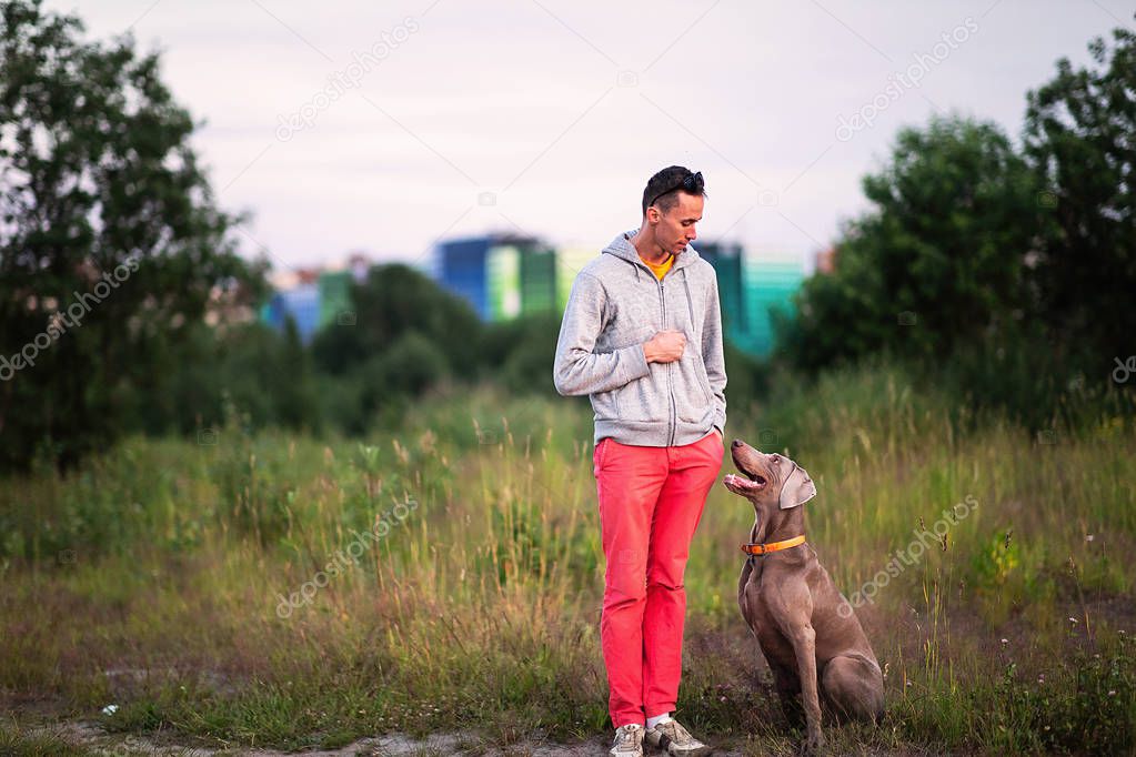 Man standing on land with dog in countryside