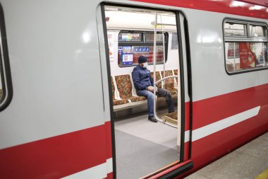 Saint-petersburg, Rusya - 04 Nisan 2020: Kendini izole ettiğin süre boyunca yan manzara kırmızı boş metro vagonu. Trenin içinde biri var.