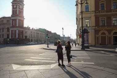 Saint-petersburg, Rusya - 7 Nisan 2020: Nevsky Prospekt. İki arkadaş yaya geçidinde dikilip konuşuyorlar. Şehirdeki izolasyon rejimine rağmen insanlar evlerinde kalmak istemiyorlar.
