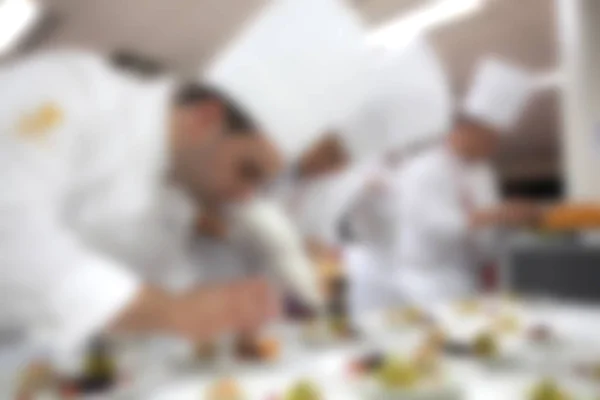 Blurry background of Chef in hotel or restaurant kitchen cooking — Stock Photo, Image