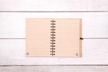 Not defterini geri dönüşümlü kağıt üzerinde ahşap masa boş.