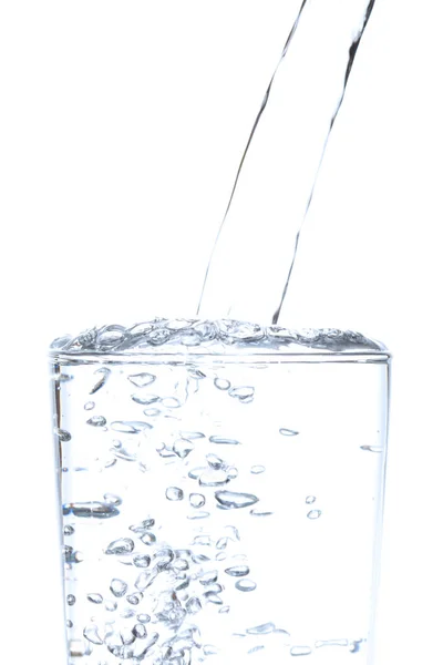 Pouring drinking water into glass on white background. — Stock Photo, Image