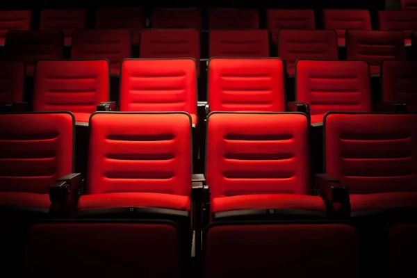 Red seat in the movie theater. Blurry background.