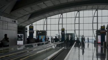 Hong Kong, Çin - Ağustos 2019: Asya 'daki uluslararası havaalanında zaman geçiren erkek ve kadın yolcular.