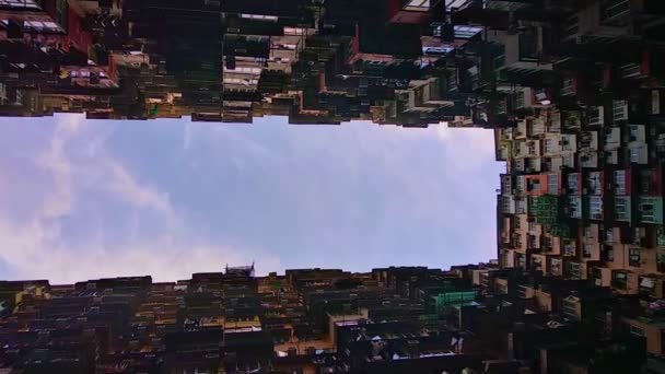 Вертикальне відео. Вид знизу житлового будинку і блакитне небо в азіатському місті влітку . — стокове відео