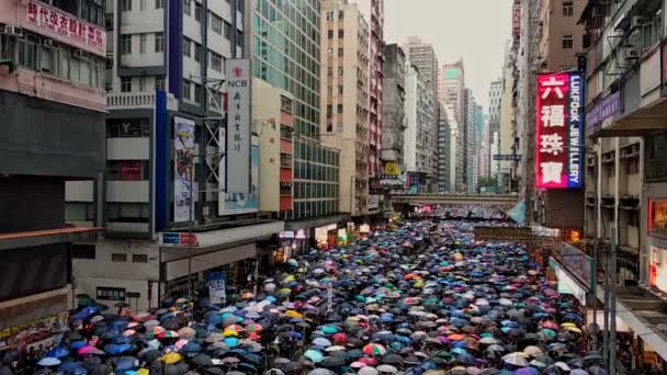 Hong Kong, China - August, 2019: peaceful demonstration of people crowd with umbrellas on street — Stock Video