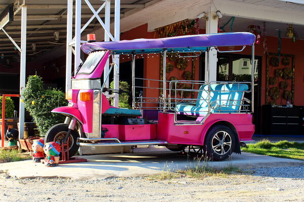 Tuk Tuk three wheeled taxi on a street Thai