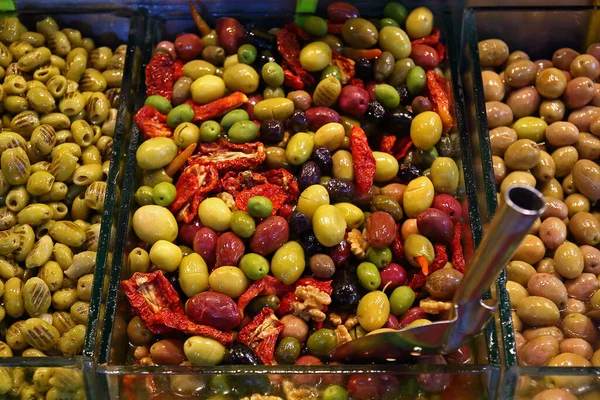 Colorful pickled olives at a street market. Selective focus