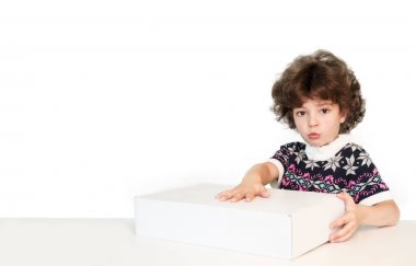 Sürpriz sevimli çocuk kameraya bakarak beyaz kutu üzerinde elini koydu. Beyaz arka plan.