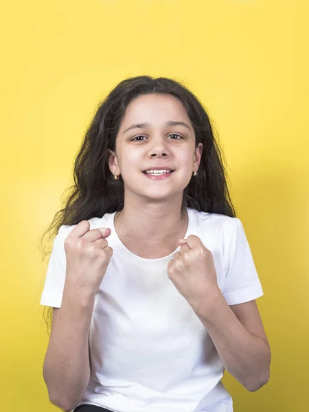 Successful happy girl. Close-up. Portrait. Yellow background. — Stock Photo, Image