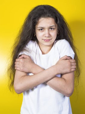 Young woman having a cold.  Yellow background. clipart