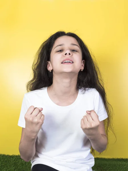 Happy girl with raised fists celebrating her victory and screaming. — Stock Photo, Image