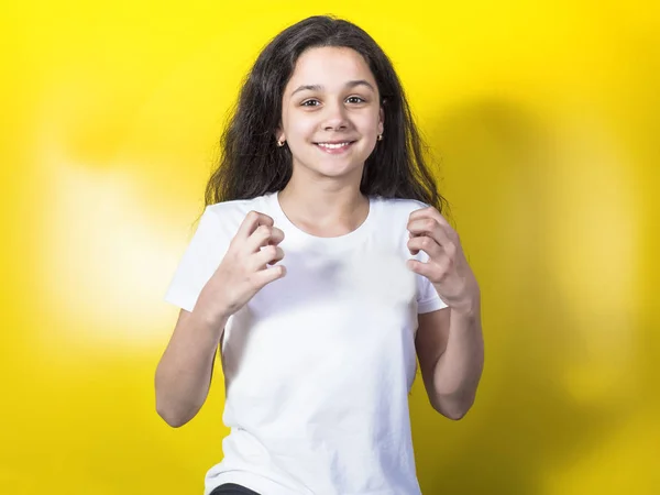 Young 11 year old girl on a yellow background — Stock Photo, Image