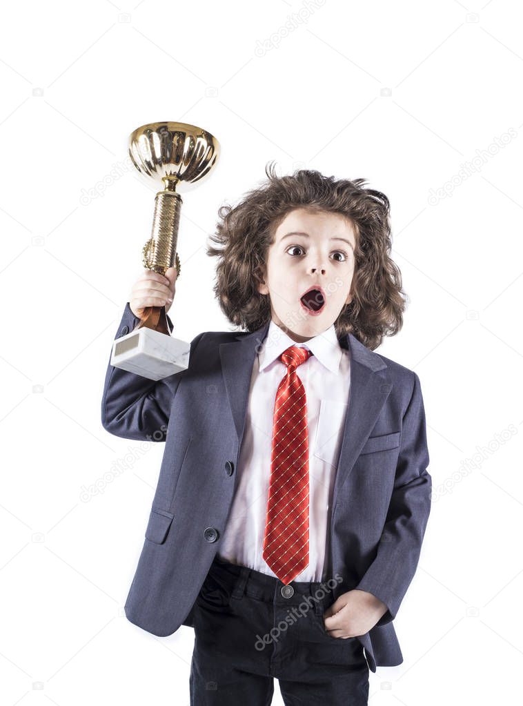 Cute little curly boy in a business suit, red tie screams and holding a cup. White background