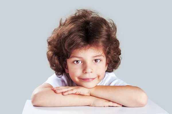 Closeup Adorable Little Boy Table Edge Smiling Head Crossed Hands — ストック写真