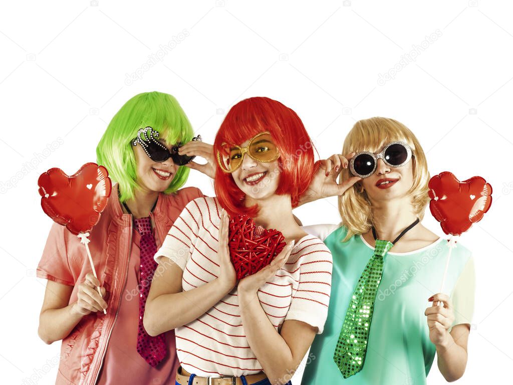 Funny young girls wearing pink wigs holding love symbols and posing for the camera on a white background