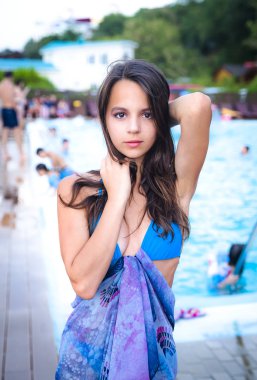 Deniz kenarında tatil yaparken gülümseyen tatlı bir genç bayan.