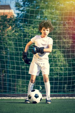 Küçük çocuklar için yaz futbol turnuvası. Futbol kulübü. Oyunun heyecanı ve neşesi. Genç kaleci. Çocuklar, futbol şampiyonu. Stadyumda futbol takımının erkek kalecisi. Spor konsepti.