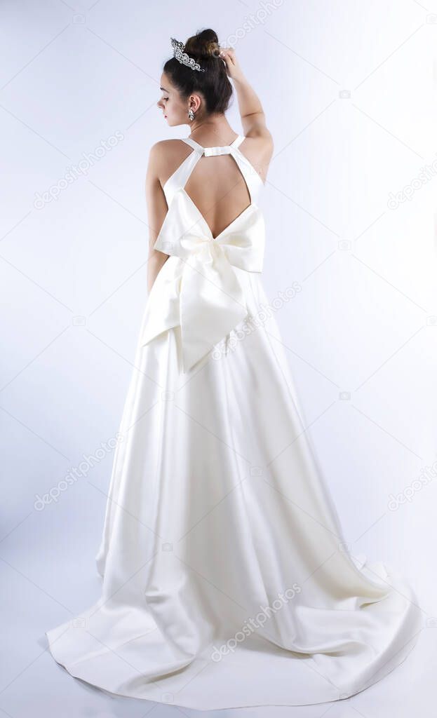 beautiful very young bride in a luxurious wedding dress and tiara