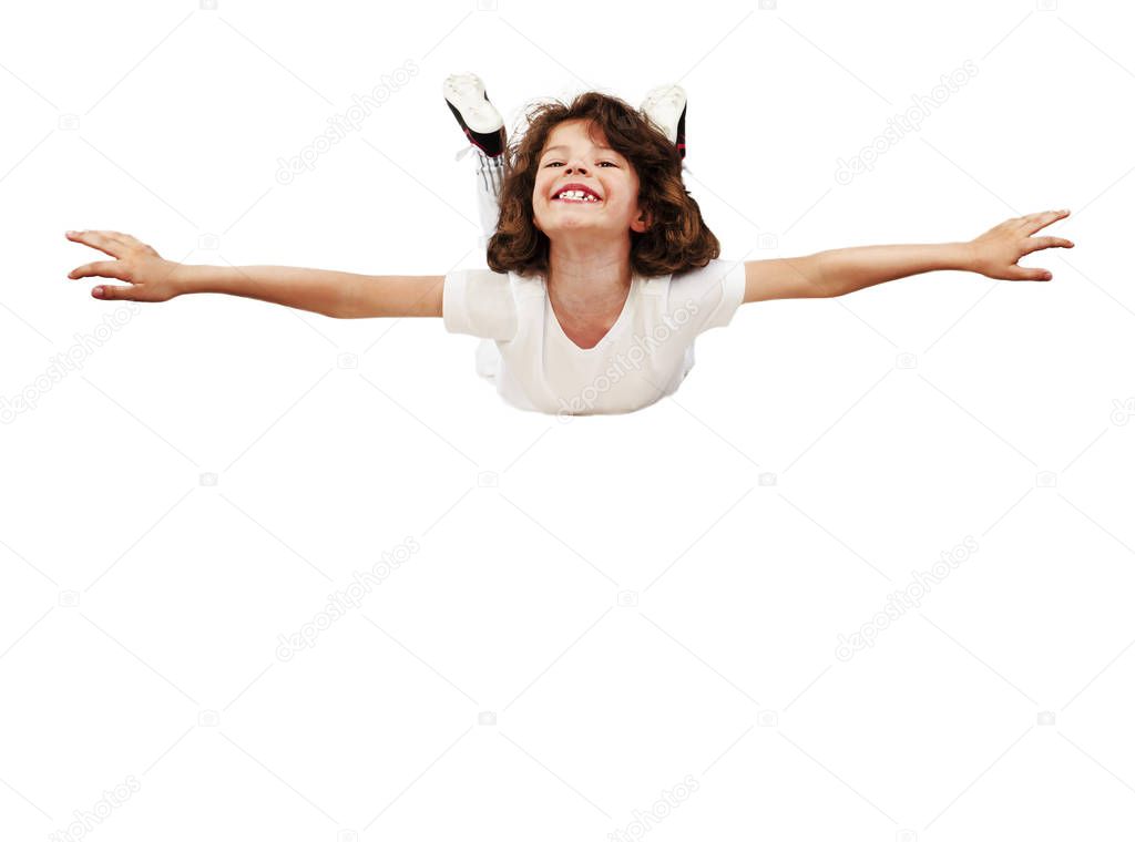 Smiling little boy in football uniform with arms raised simulating flight against a white background. Isolated on white. Copy space