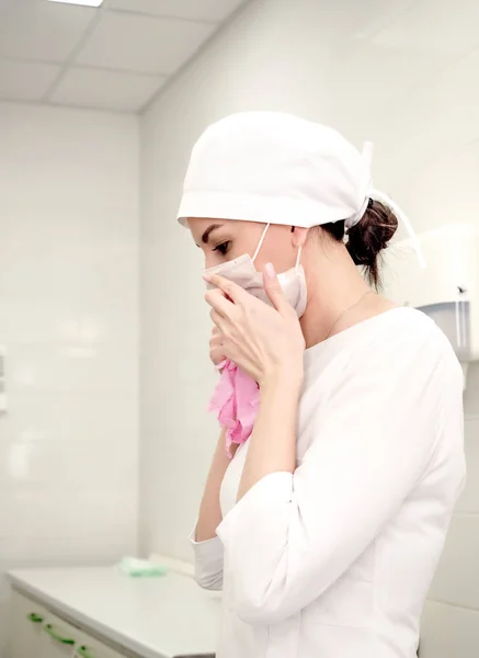 woman doctor wearing a medical mask. Surgeon, nurse or beautician doctor woman wearing medical uniform. Profile