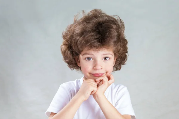 Charmant Petit Garcon Aux Cheveux Boucles Regarde La Camera Fond Gris Gros Plan Portrait Reves Stock Photo Charmant Petit Garcon Aux Cheveux Boucles Regarde La Camera Fond Gris Gros Plan Portrait Reves Stock Photo