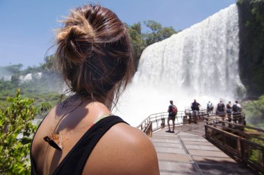 Woman Watching San Martin Fall at Iguazu Falls on background clipart