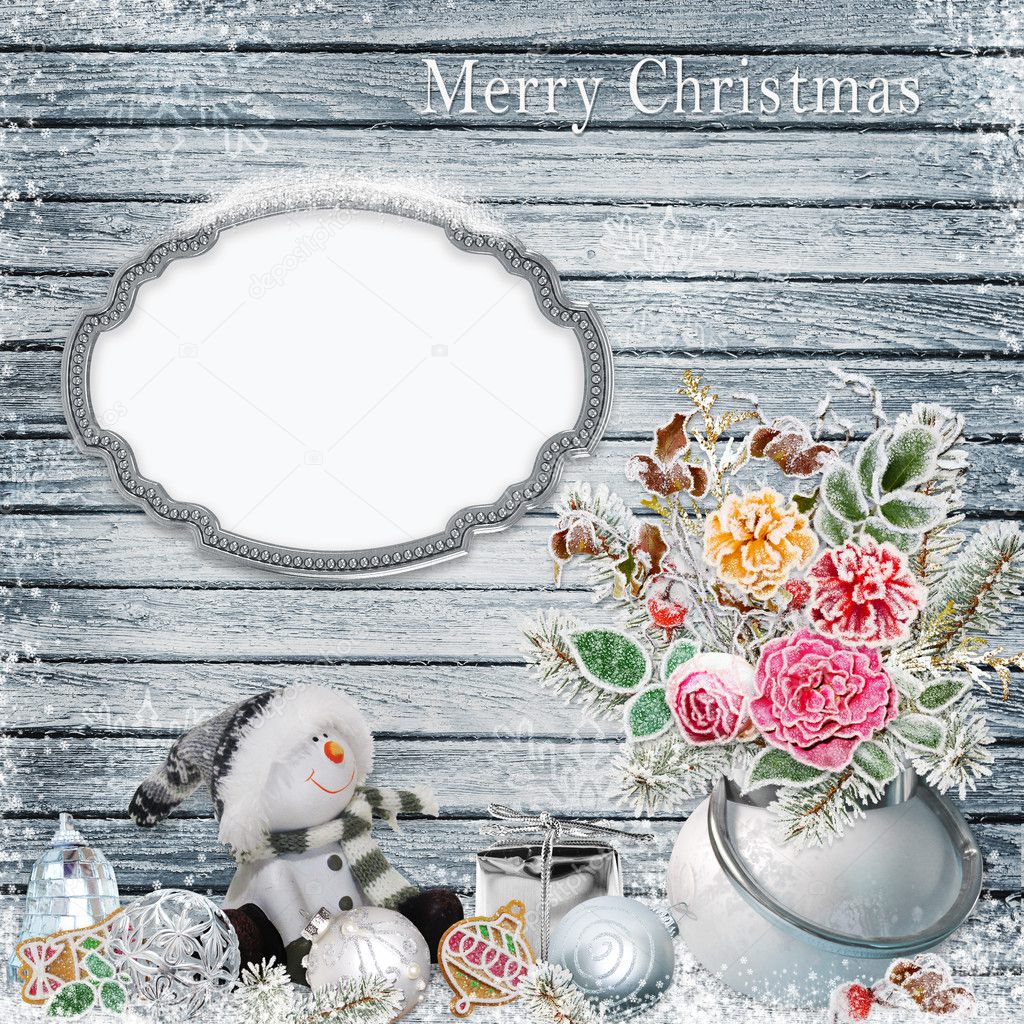 Christmas background with a bunch of flowers with frost, snowman, frame for text or photos, Christmas decorations on a snowy wooden board