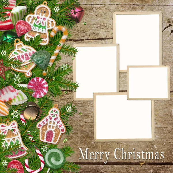 Christmas cookies, candy, photo frames, pine branches on a wooden background — Stock Photo, Image