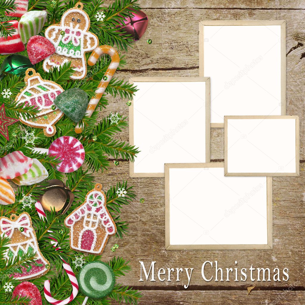 Christmas cookies, candy, photo frames, pine branches on a wooden background