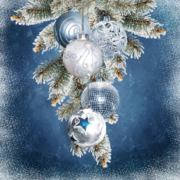 Beautiful christmas balls and pine branches on a blue snowy background — Stock Photo, Image