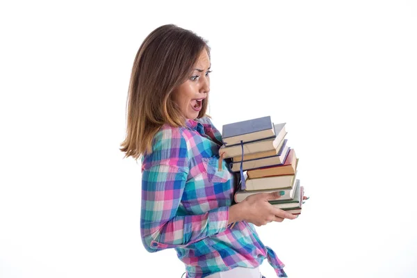 Beautiful female student carrying heavy books — Stock Photo, Image