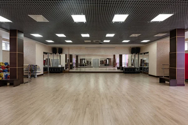 Group fitness room. Modern interior design. Fitness workout. Fitness gym background. Gym equipment background. Empty space. large and light hall with mirrors, music, equipment for dancing, sports.