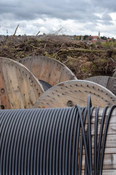 Cable drums in front of rural Background