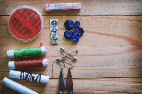 Set of sewing tools on wooden table — Stock Photo, Image