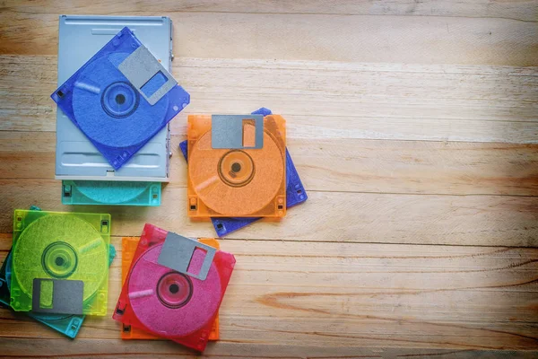 Floppy disk drive and diskettes on wooden table, old technology and legacy industrial computer equipment — Stock Photo, Image