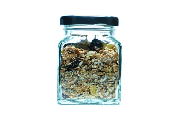 Granola o muesli en frasco de vidrio sobre fondo blanco — Foto de Stock