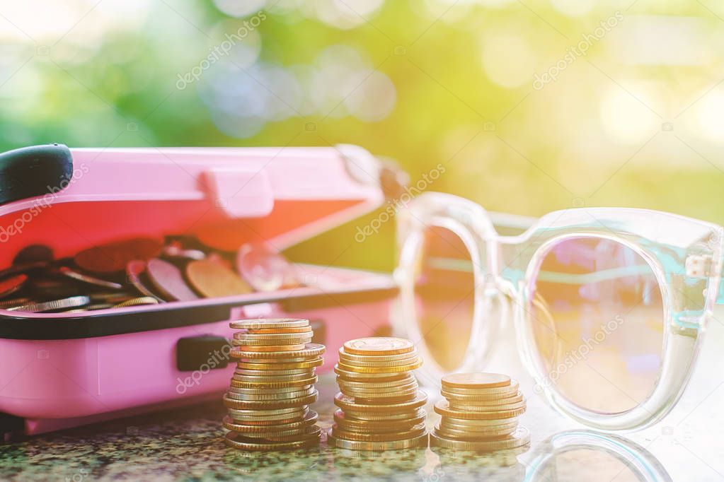 Coins in pink luggage and outside with fashion sunglasses