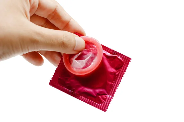 Hand holding male condom with package on white background — Stock Photo, Image