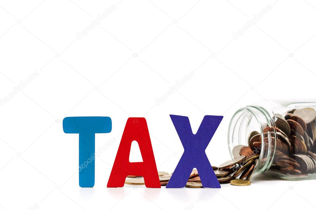 TAX wooden word with pile of coins in the glass jar on white bac