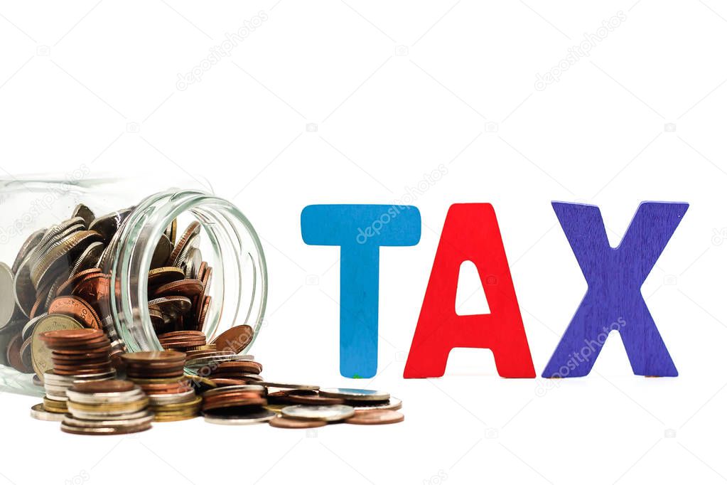 TAX wooden word with pile of coins in the glass jar on white bac