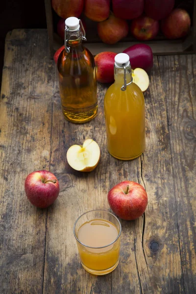 Bottles and glass of apple juice — Stock Photo, Image