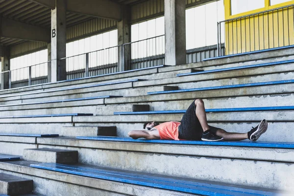 Young Man Headphones Lying Grandstand — Stock Photo, Image