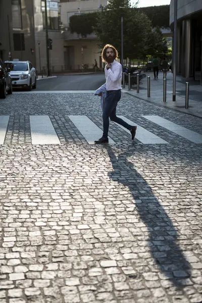 Businessman walking on zebra crossing — Stock Photo, Image