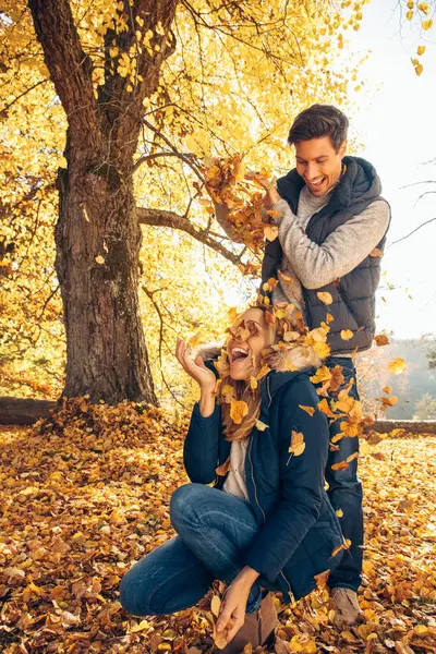 Couple having fun in autumnal forest — Stock Photo, Image