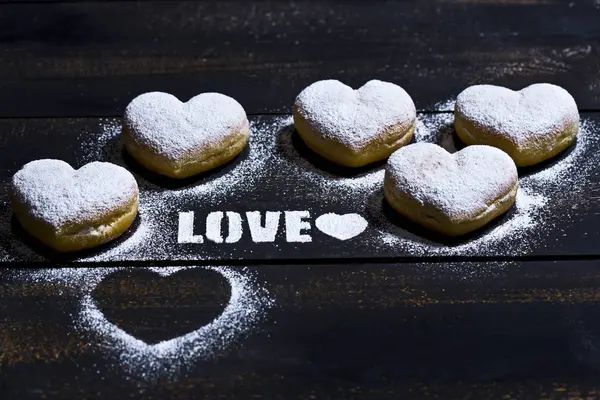 Word Love Stenciled Icing Sugar Five Heart Shaped Crullers Dark — Stock Photo, Image