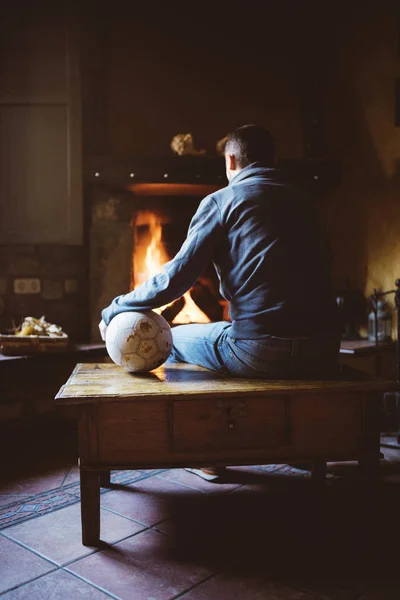 Man Sitting Front Fireplace Soccer Ball — Stock Photo, Image