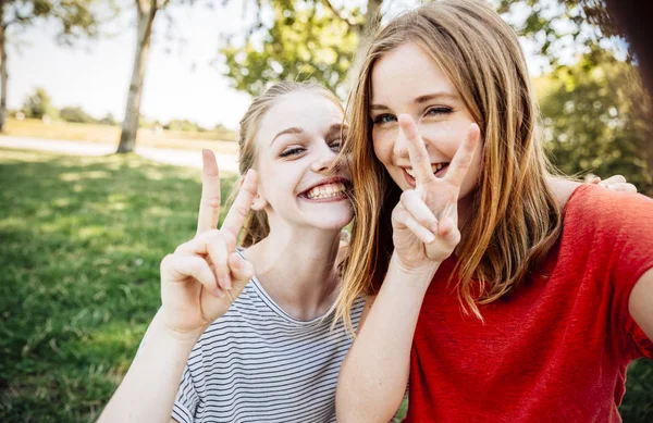 Twee Speelse Tienermeisjes Overwinning Teken Maken — Stockfoto