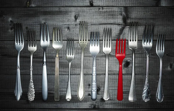 Row Different Silver Forks Red Plastic Fork Wood — Stock Photo, Image