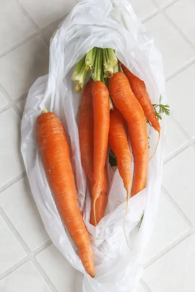 Fresh carrots in plastic bag — Stock Photo, Image